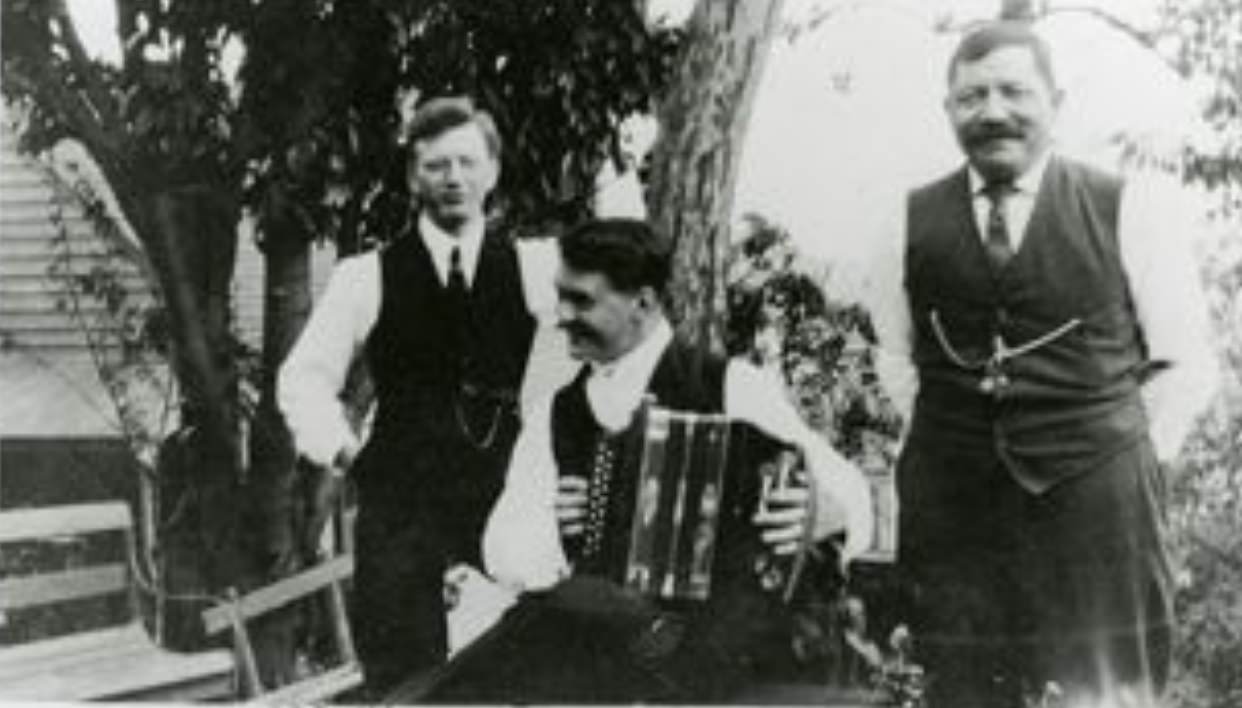 #132 Portrait of Frank Schoenstein, an unknown person with accordion, and Mr. Imdorf, early 1900s