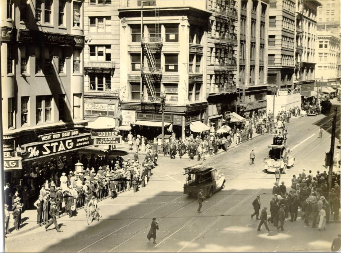 #56 Crowd of people watching workers repair a broken trolley cable on Kearny Street near Market, 1935