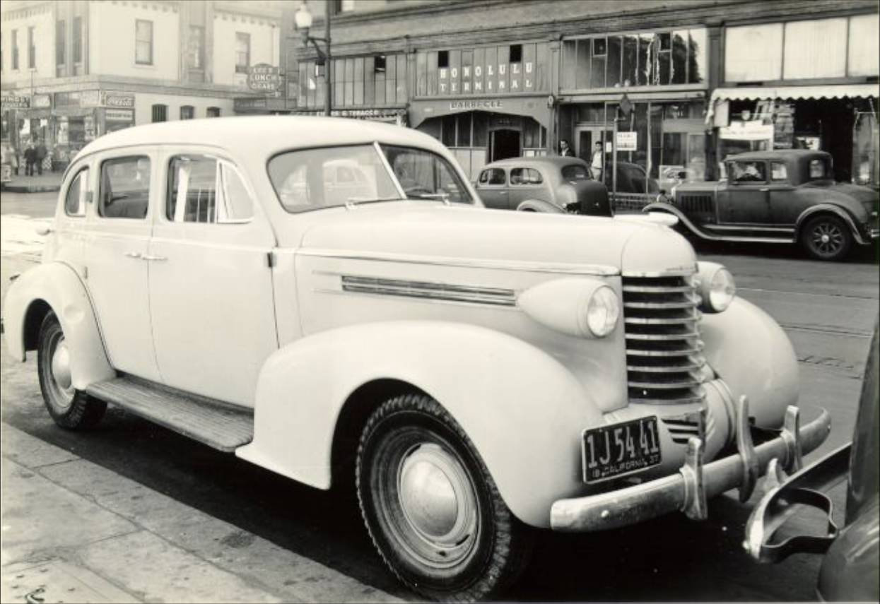 #88 Closeup of a 1937 Oldsmobile parked on Kearny Street near Jackson, 1937