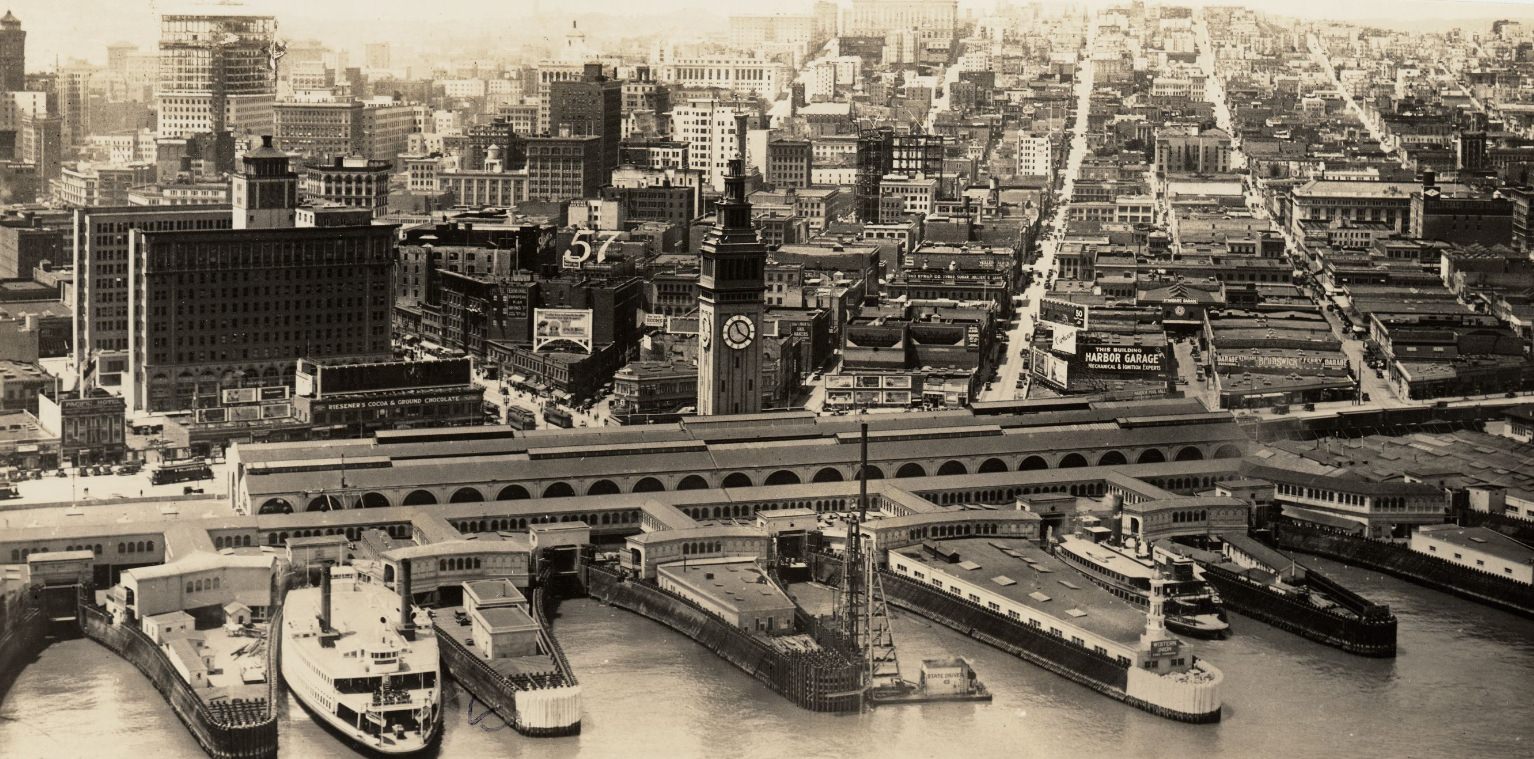 #144 Aerial view from the Bay, looking southwest, of ferry boats, piers, and the Ferry Building, 1930