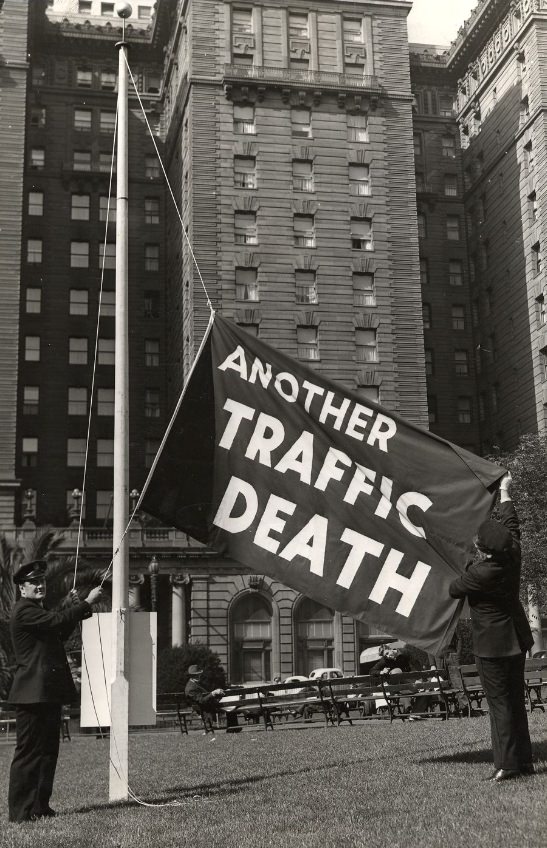 #44 Officers Ed Connell and Frank Dunphy raise the “another traffic death” flag in Union Square, 1939