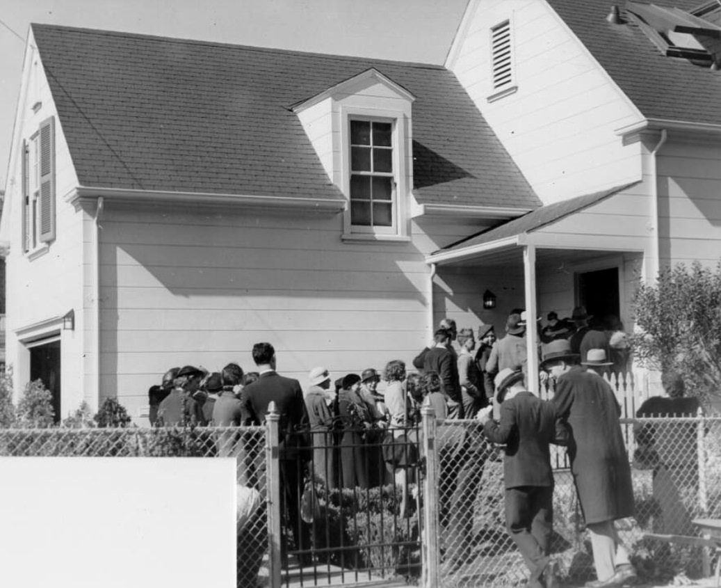 #62 Crowd waiting in line to enter a home near the Civic Center, 1935