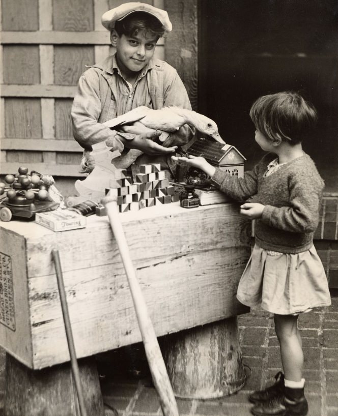 #79 Community Chest girl and boy at a toy stand, 1934