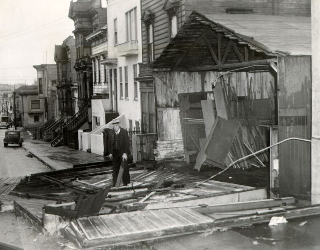 #272 Al Simon in front of his wind-damaged cabinet shop at 2555 Post Street, 1943