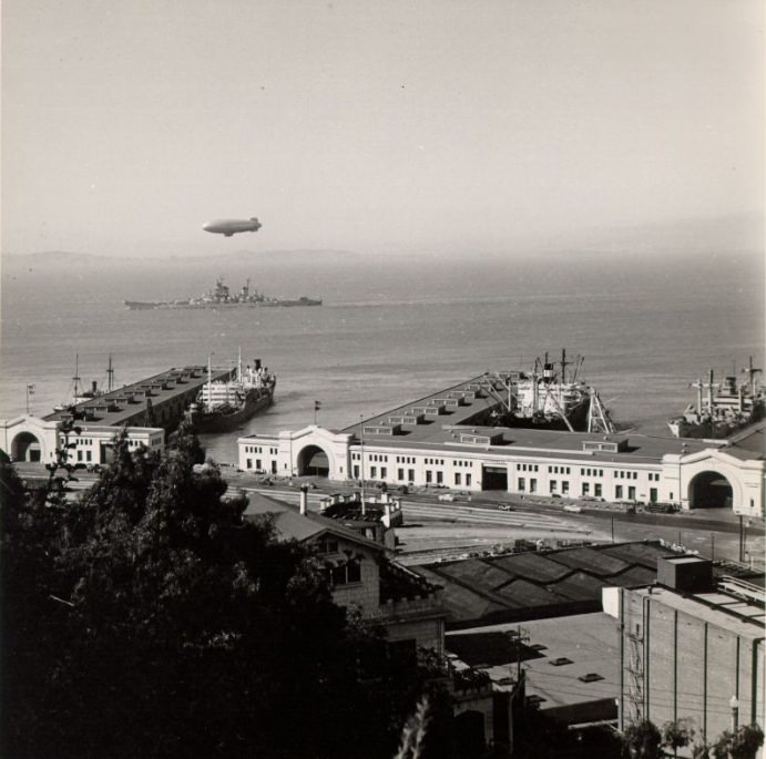 #102 Blimp over a ship off Pier 34 in San Francisco Bay, 1940s