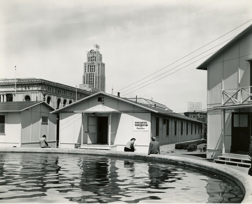#10 Three people sitting at a fountain in front of the Temporary Barracks, Civic Center Plaza, 1940s