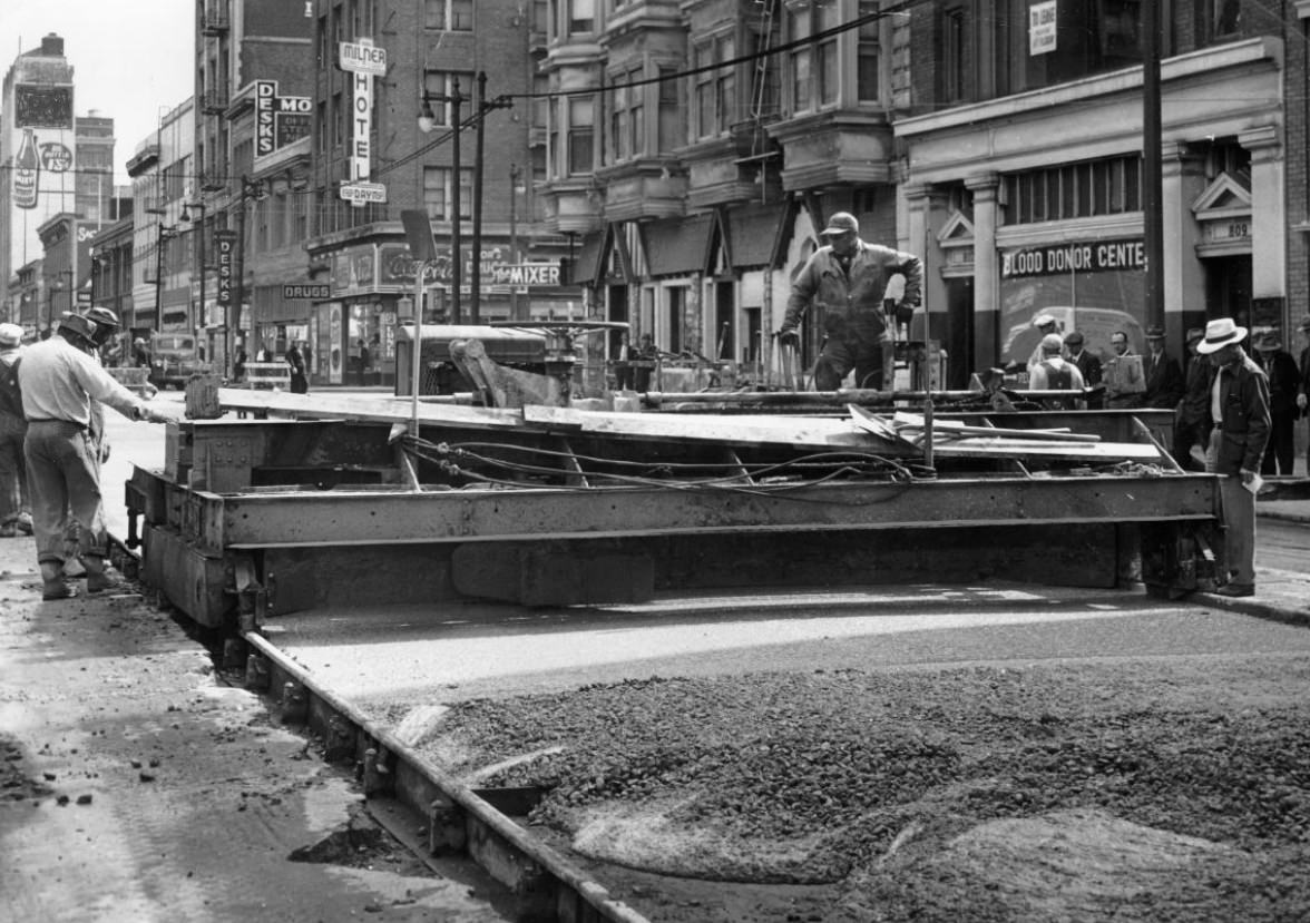 #228 Workers operating a concrete spreader on Mission Street, 1944