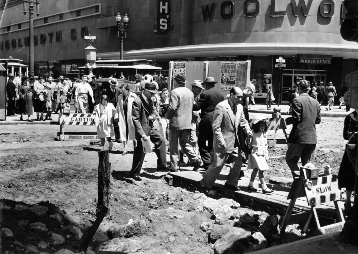 #129 Pedestrians on a temporary walkway at Powell and Eddy Street, 1953.