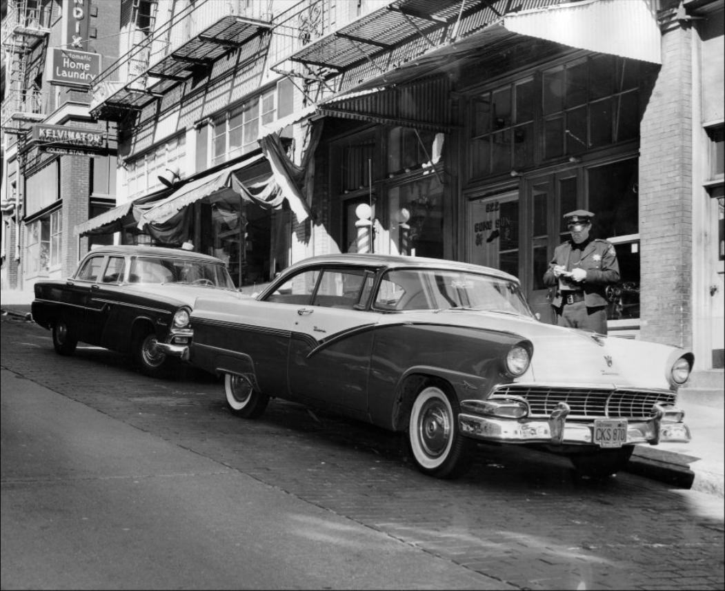 #206 Police officer issuing a parking ticket on Clay Street, 1956.