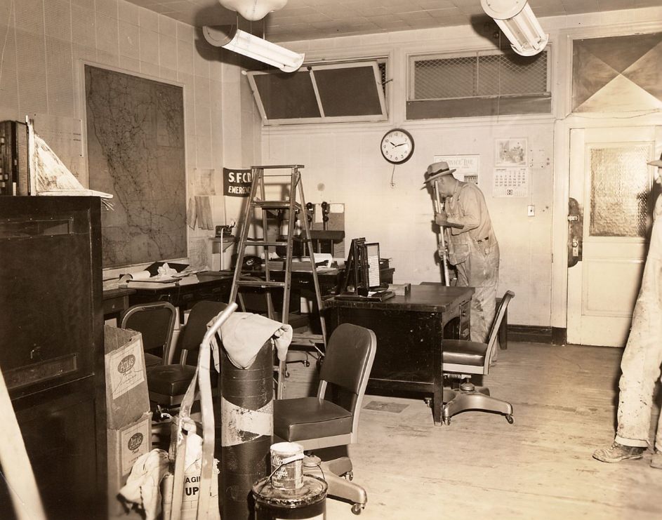 #212 Janitors cleaning a small office in the Old Hall of Justice, 1958.
