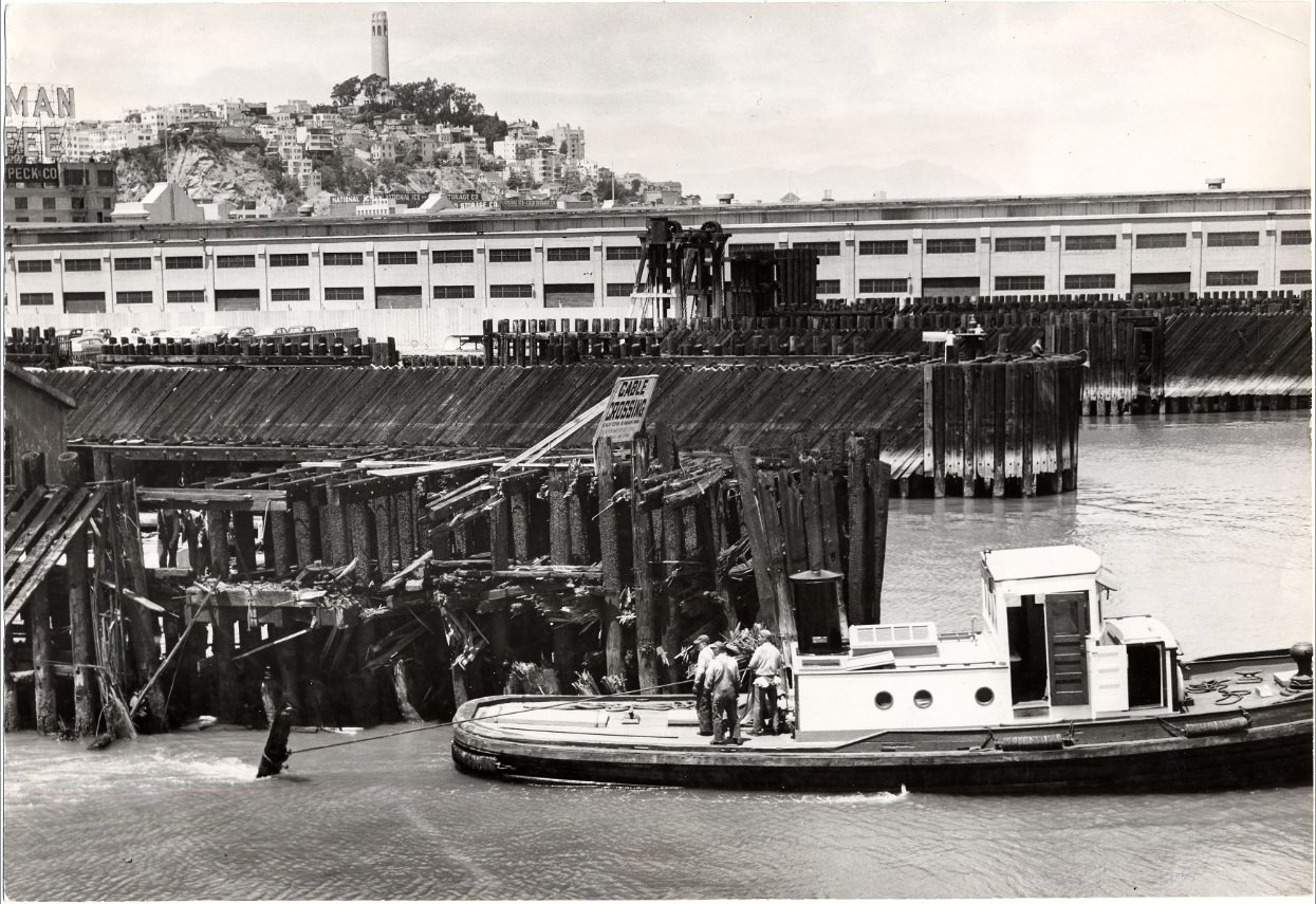 #217 Tugboat Gov. Stephens pulling debris from the channel leading to the Southern Pacific pier, 1954.