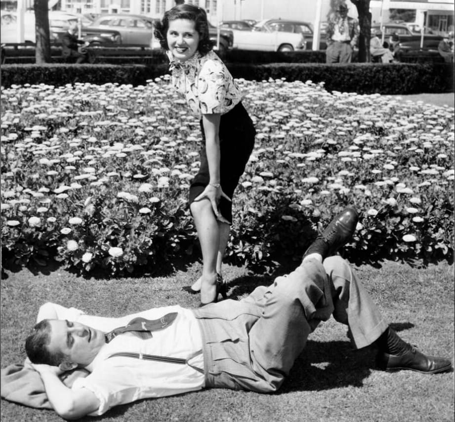 #69 Ameila Balian near sleeping Baron Muller on Civic Center Plaza lawn, 1951.