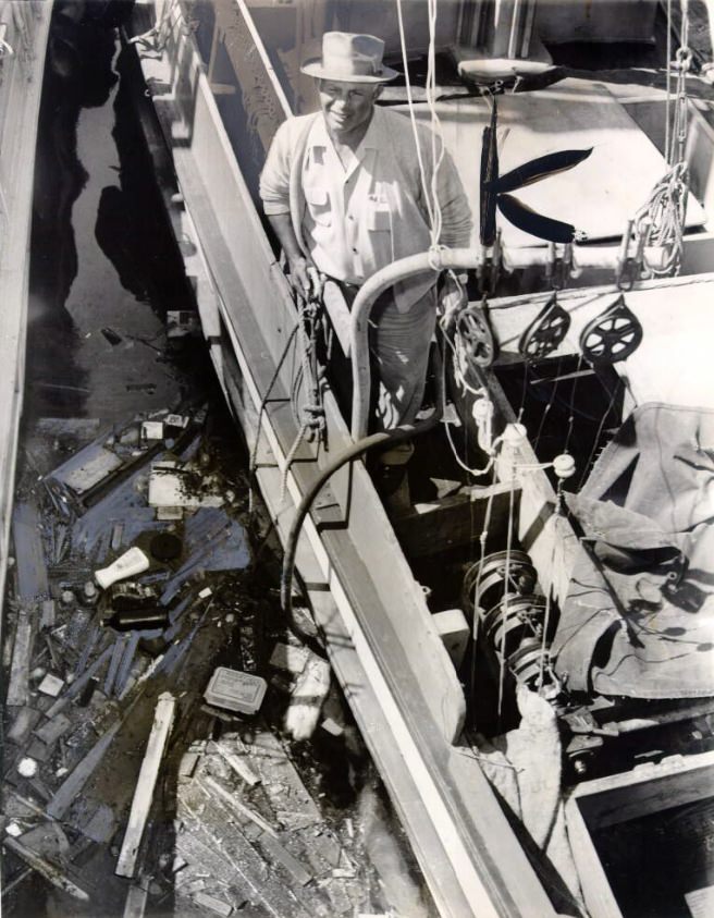 #117 Vincent Spadaro looking at swirling debris in the bay, 1960.