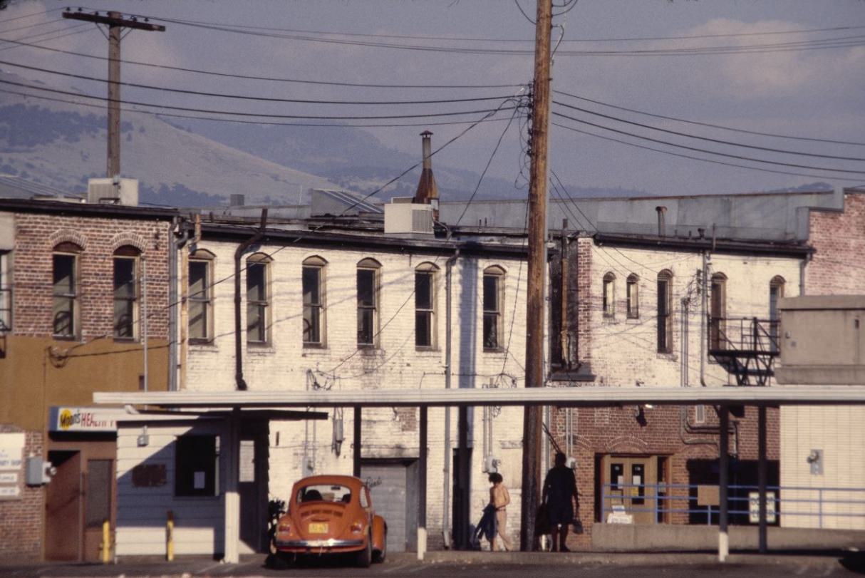 #96 People walking by withered buildings, 1978.