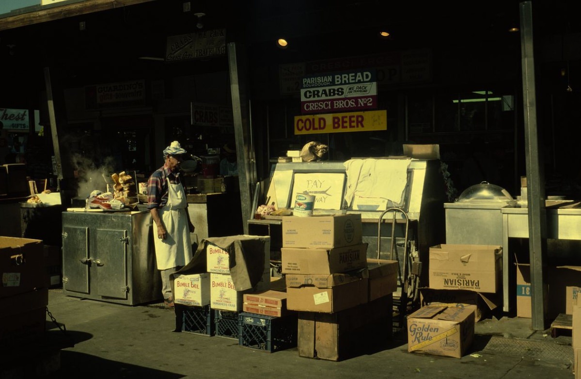 #111 Person outside with delivery at Guardino’s seafood restaurant, 1978.