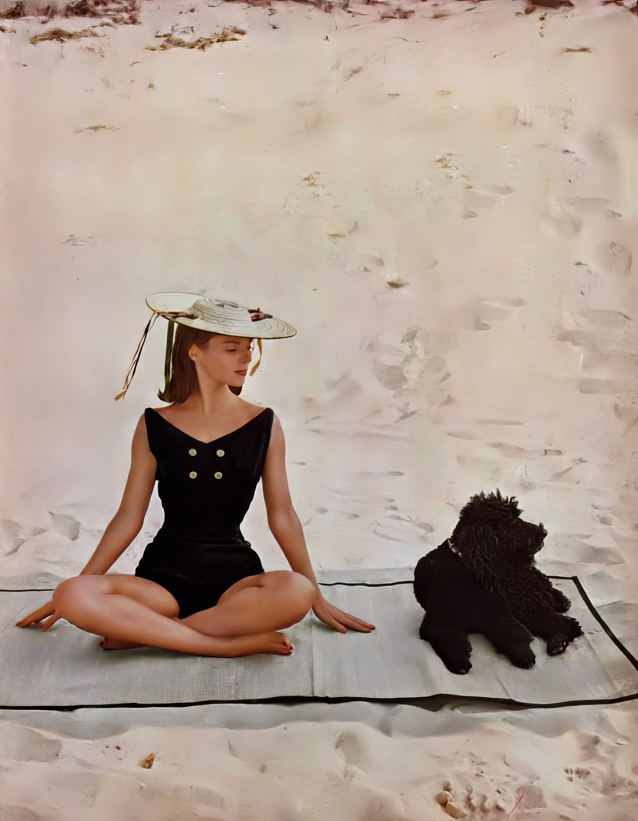 #21 Model in a black knit bathing suit by Sportwhirl, Harper’s Bazaar U.S., December 1956.