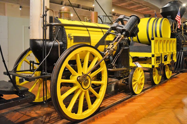 #1 1829 Stephenson ‘Rocket’ at the Henry Ford Museum. Robert Stephenson built the ‘Rocket’ in 1829 as the winning entry in a locomotive design contest. Though quite simple in design, the locomotive attained a speed of 29 1/2 mph