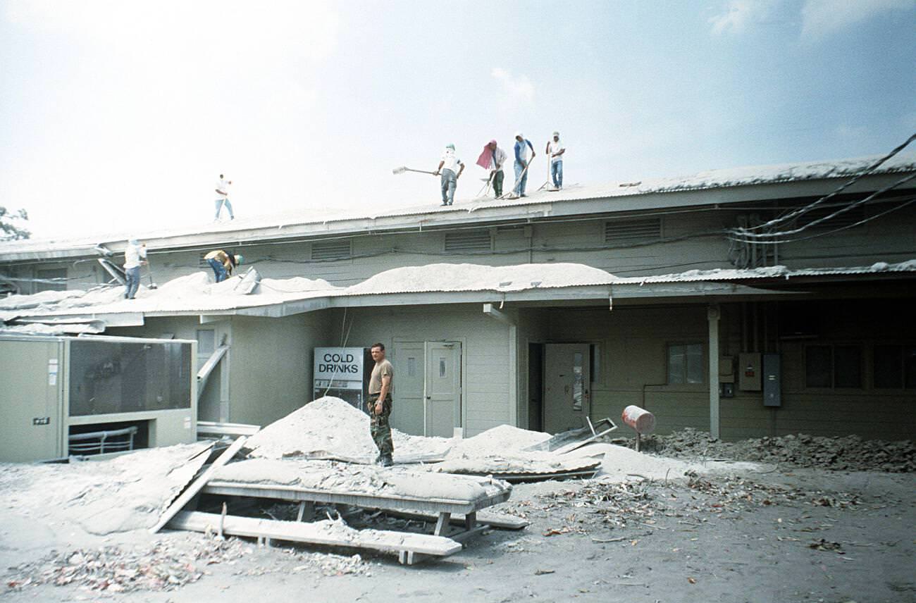 Airmen and Filipino workers clearing volcanic ash from a roof at Clark Air Base, Luzon, Philippines, after Mount Pinatubo’s eruption.