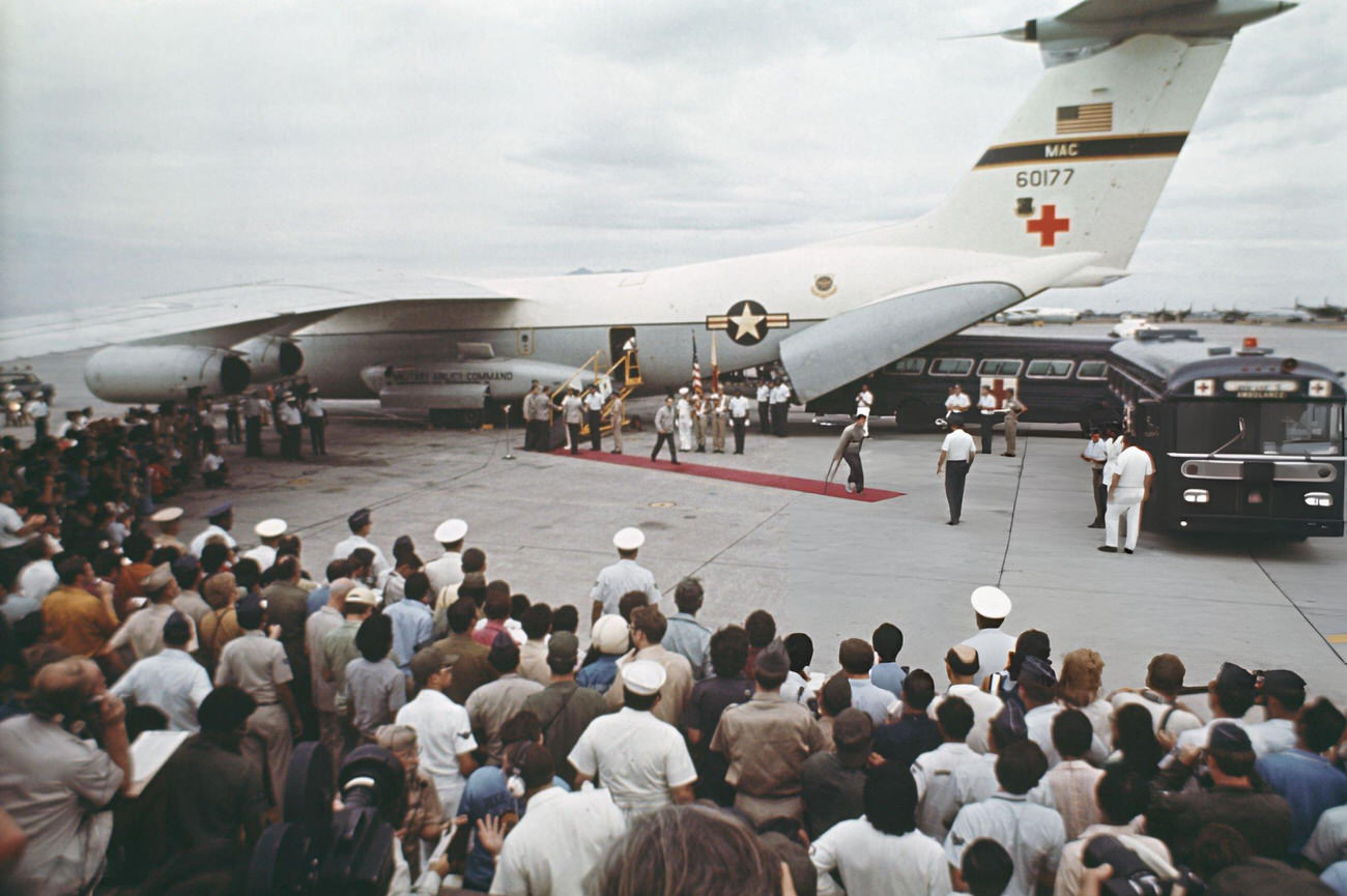 #34 American POWs return from Vietnam, walking from a Lockheed C-141 Starlifter to ambulances at Clark Air Base, Philippines, February 1973.