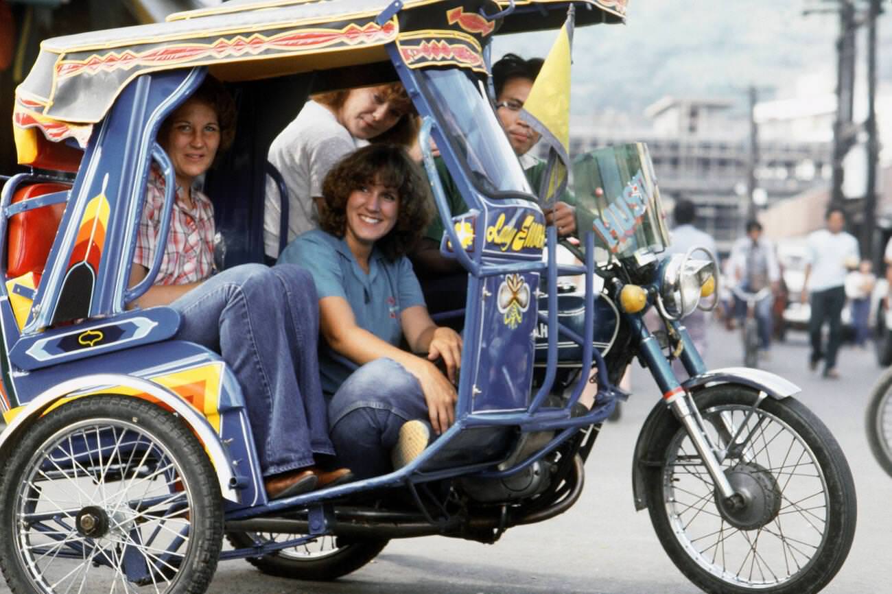 #41 Dependent wives of USS STERETT crewmen riding in a jeepney, Philippines, 1982.
