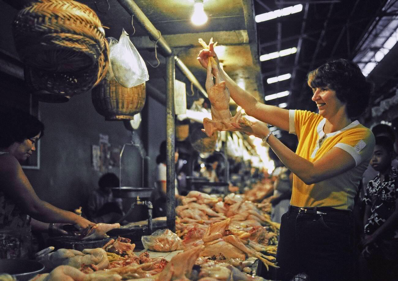#44 A dependent wife shopping for poultry in the Philippines, 1982.