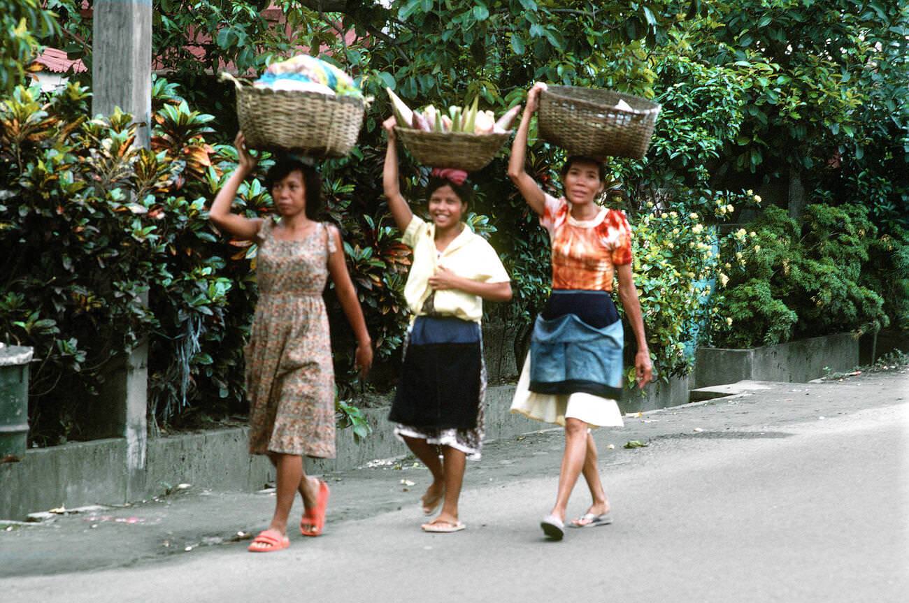 #49 Women carrying baskets on their heads, 1981.