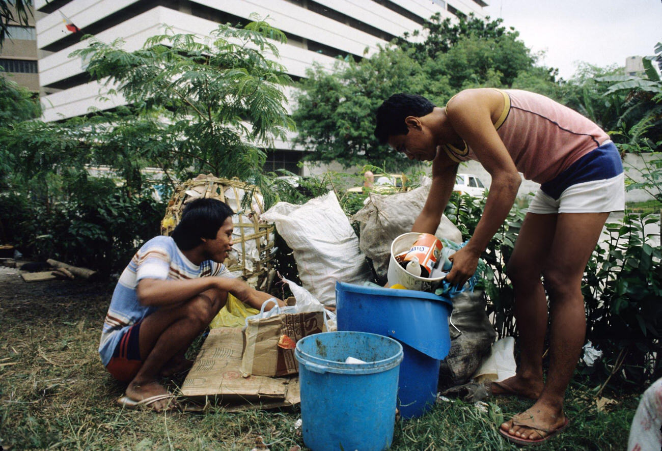 #66 People scavenge garbage near Roxas Boulevard amidst mass demonstrations of the People Power Revolution in Metro Manila, 3rd March 1986.