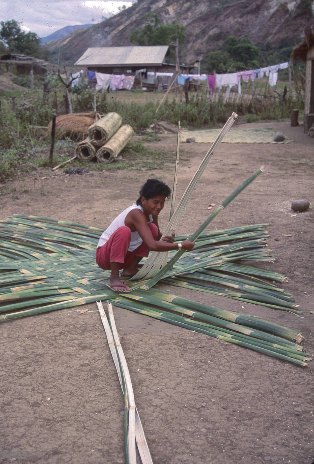 #76 A woman crafts bamboo mats in Mountain Province, Philippines, July 1988.