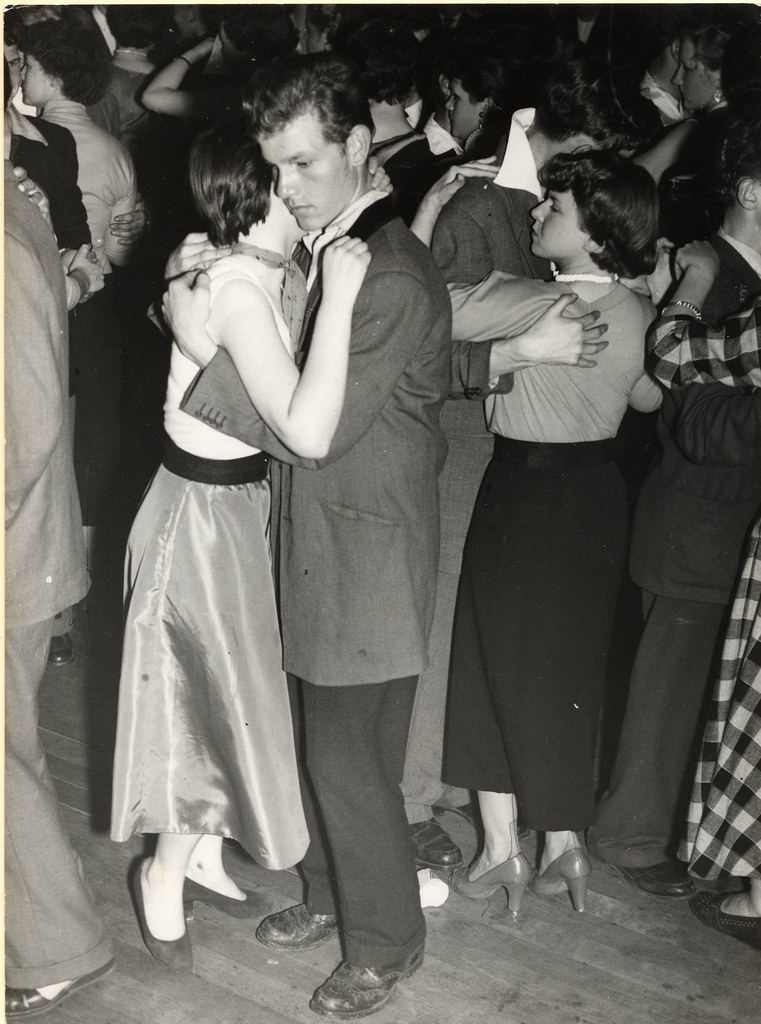 #10 A Teddy Boy with his girl ‘Moon Dance’ at a Dance Hall – July 1955 – note the Drape Jacket with half back full velvet collar with 16-17″ turned up trousers and Brogue Shoes.
