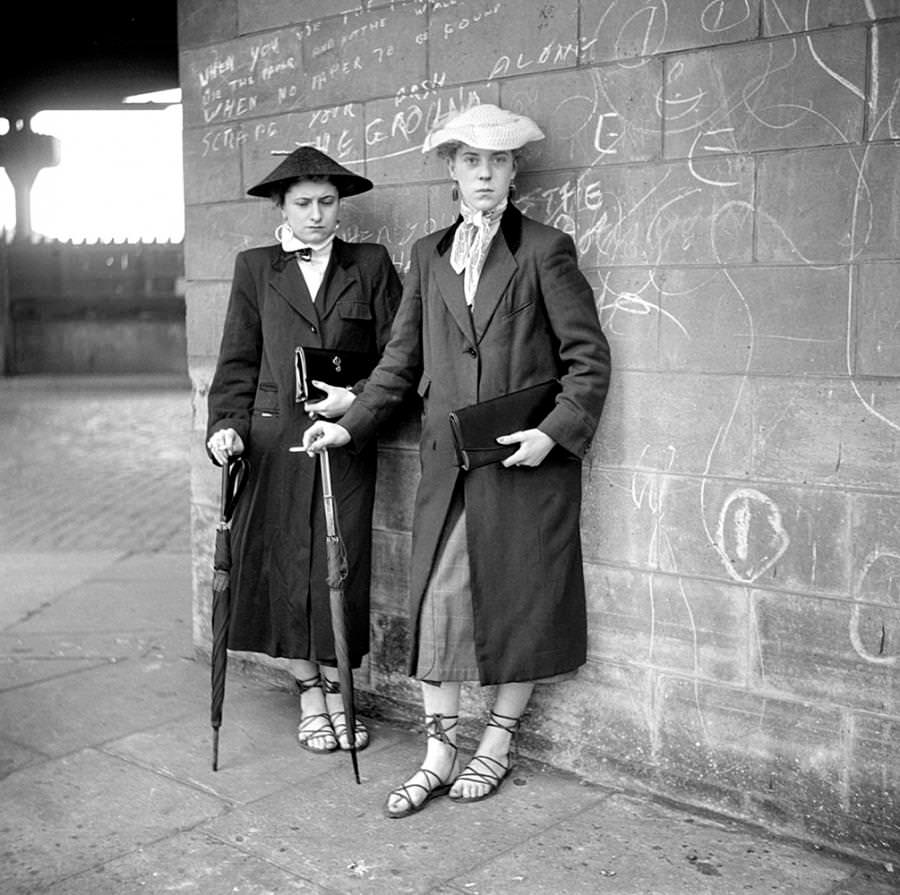 #8 Photograph by Ken Russell January 1955 of Teddy Girls, Pat Wiles and Iris Thornton, aged 17 from Plaistow, showing off their lace up espadrilles.