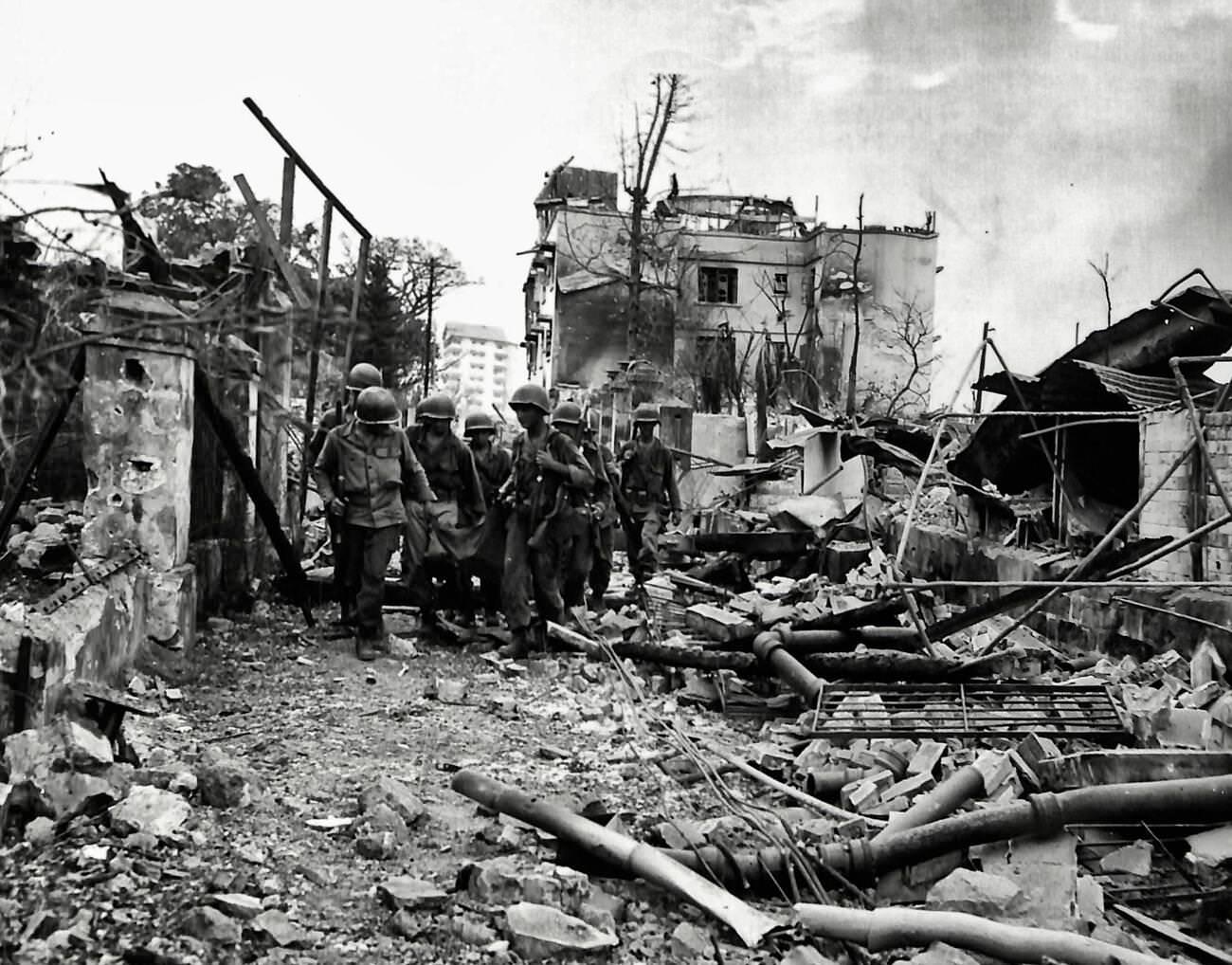#75 Troops from the 5th Troop, 1st Cavalry, advance cautiously down Taft Avenue in Manila, Philippines, 1945.