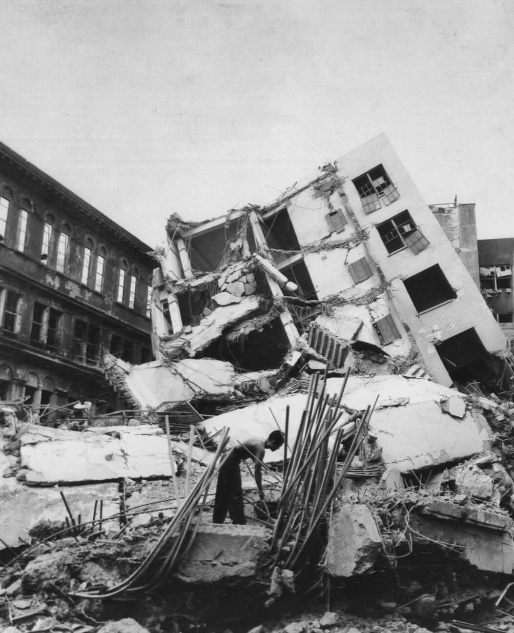 #39 A building on the Escolta in Manila is dislodged and tipped over by an explosion during the battle for Manila, 1945.