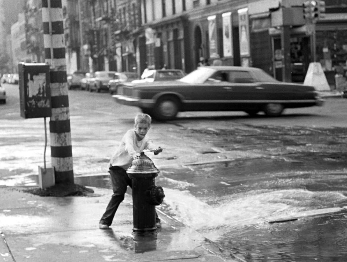 #17 Fernando in charge of a hydrant on 2nd Avenue and 3rd Street, 1975.