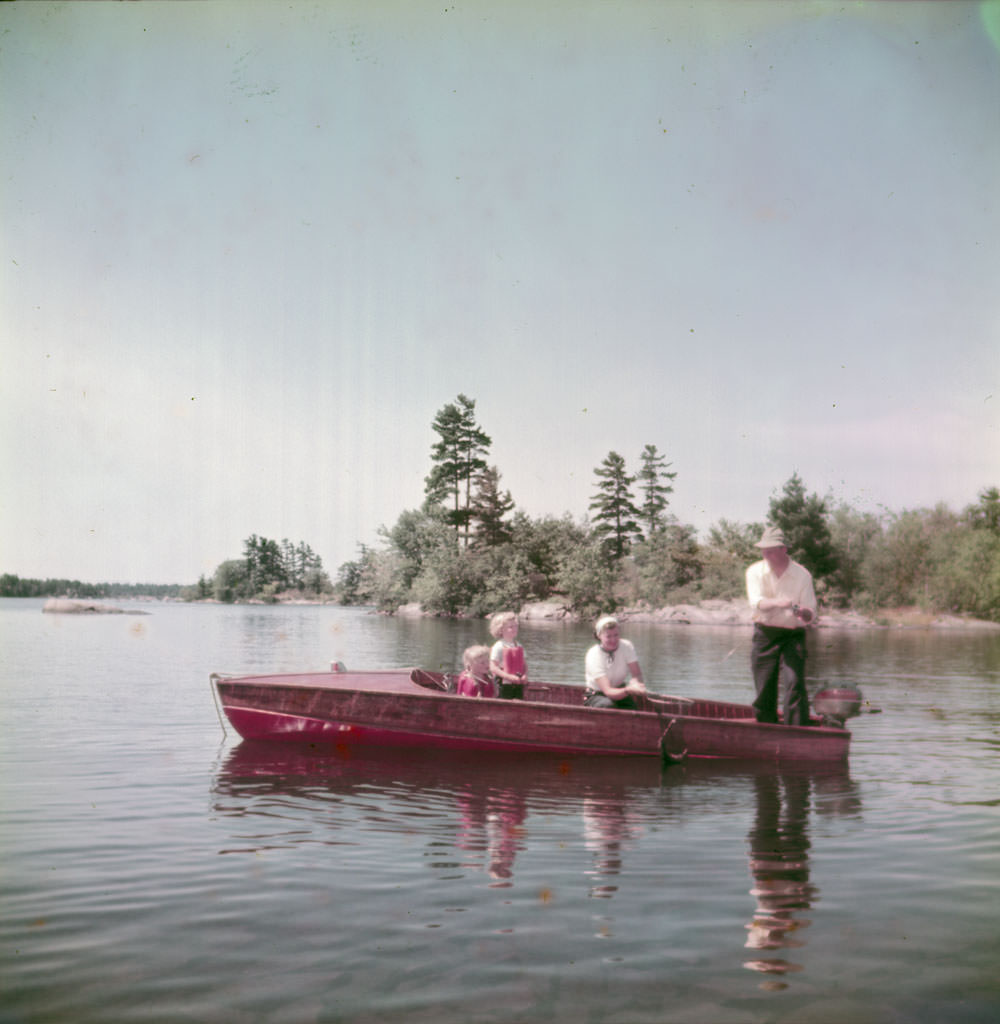 #5 Father, mother and two little girls fly-fish in a boat on Story Lake, Ontario, 1951