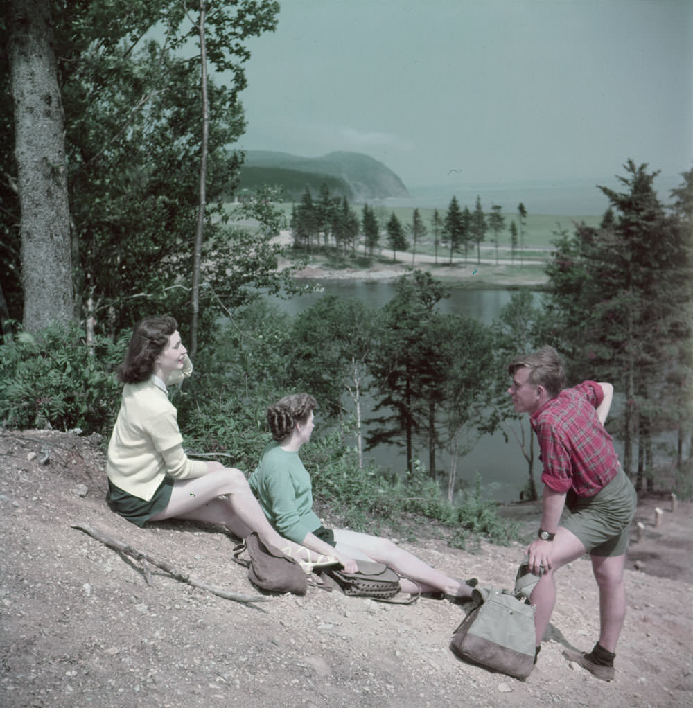 #9 A man and two women rest on a hill above MacLaren Pond while hiking in Fundy National Park, New Brunswick ,1950