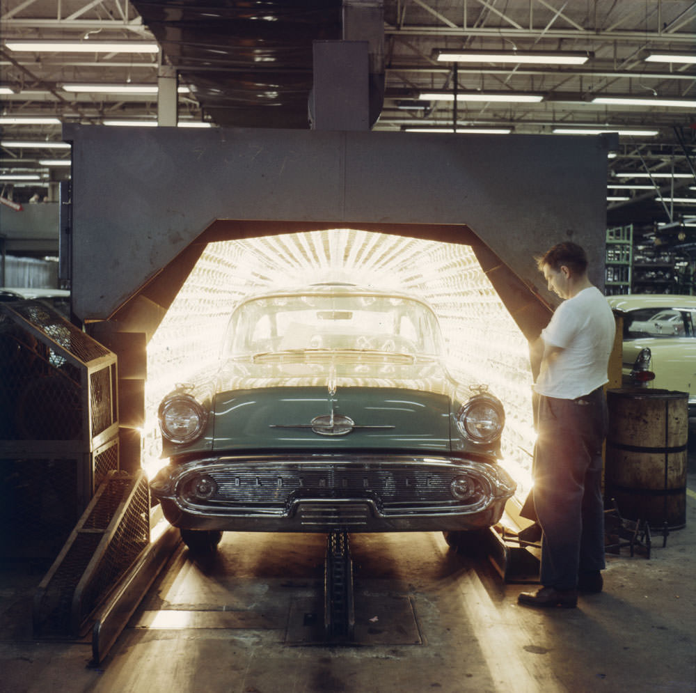 #12 An automobile exits a drying oven after being painted, General Motors, Oshawa, Ontario, 1959