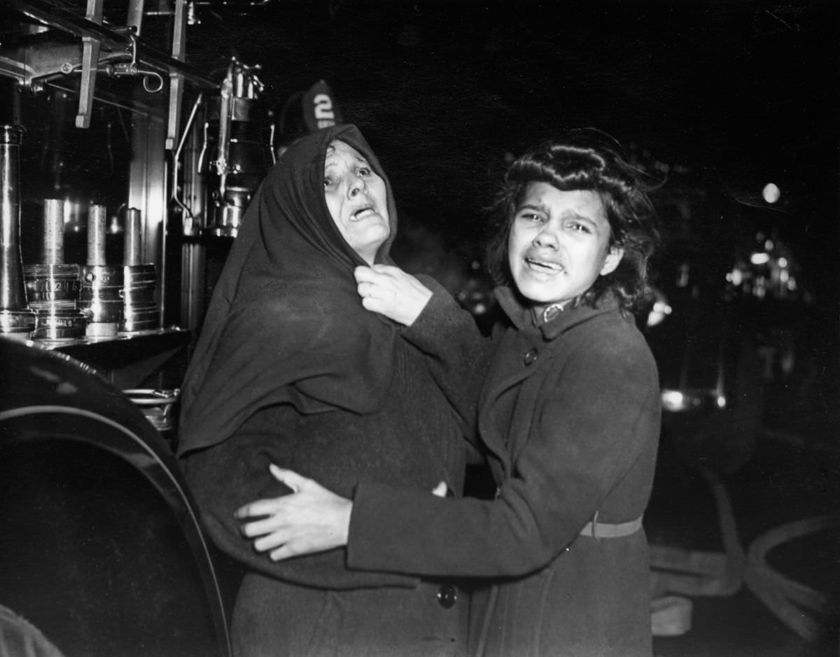 #13 Henrietta Torres and her daughter Ada outside a tenement fire, 1939.