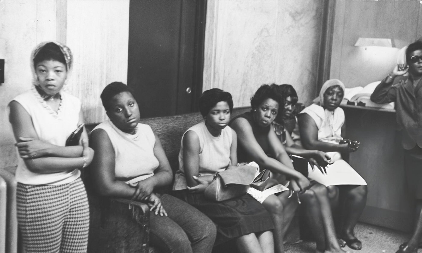 #26 A group of women in a police station as they wait to pick up relatives picked up by police for looting during riots