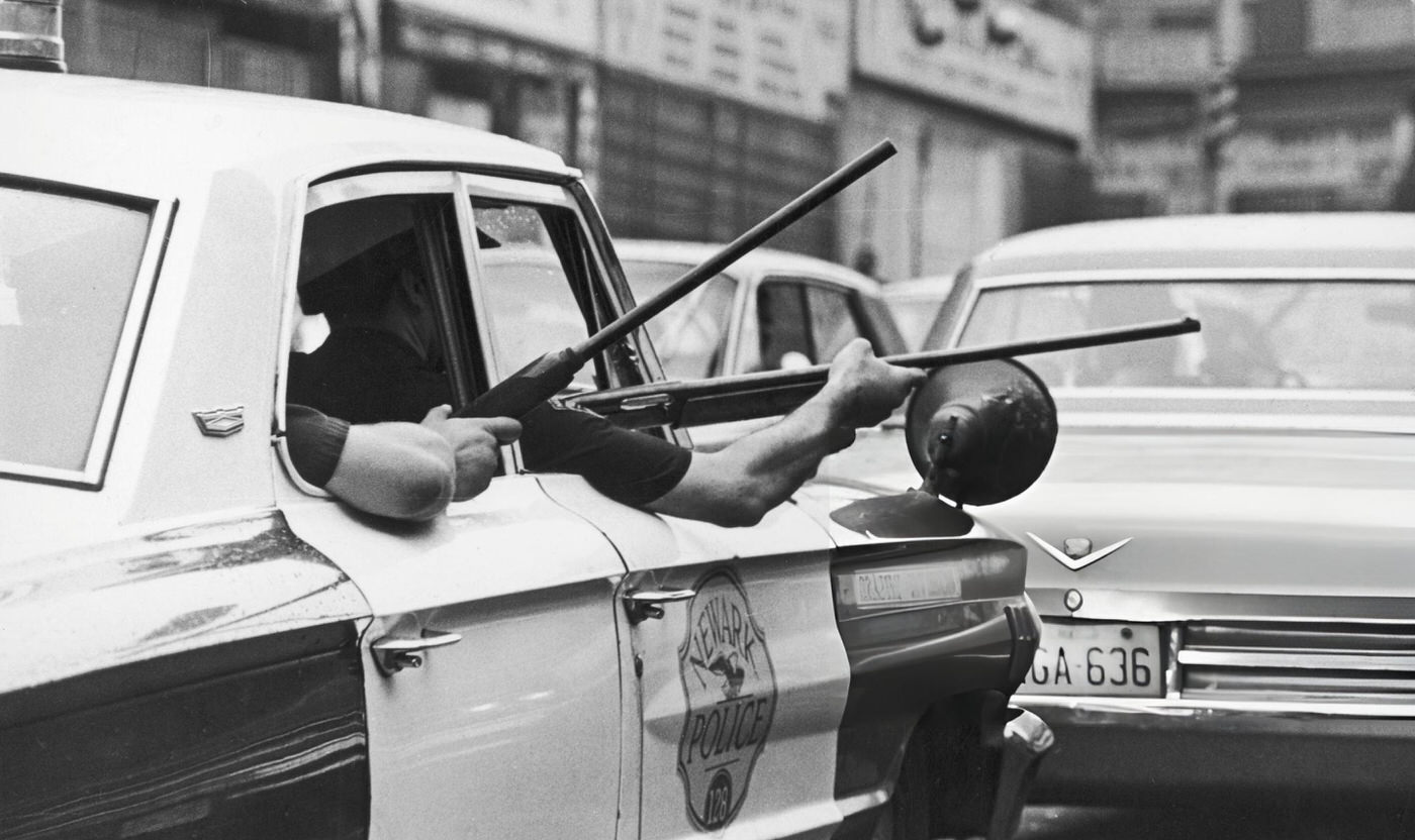 #8 Police officers hold rifles out of the windows of a police cruiser on Springfield Avenue