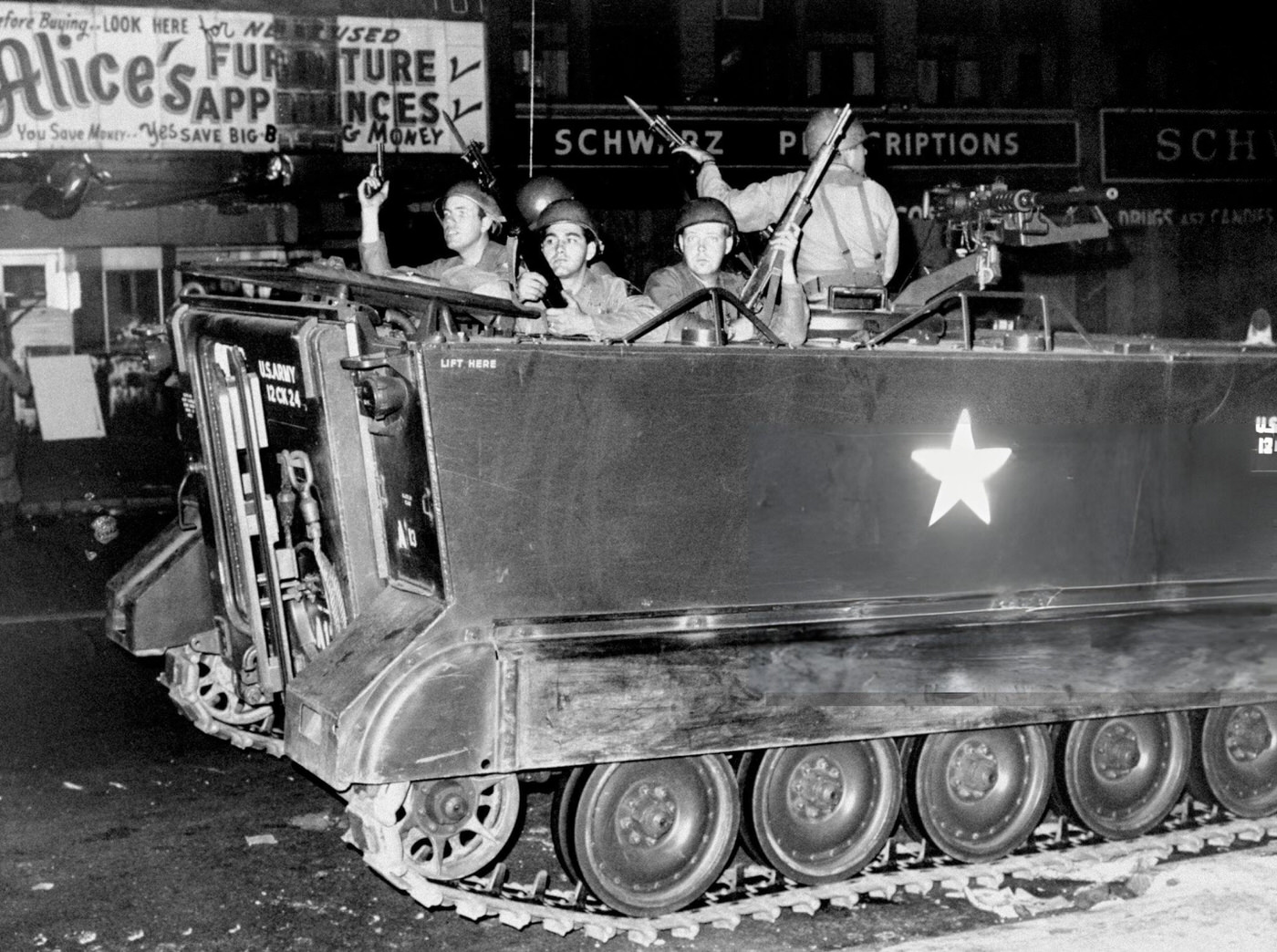 #38 Soldiers in an armored personnel carrier patrol the streets of Newark