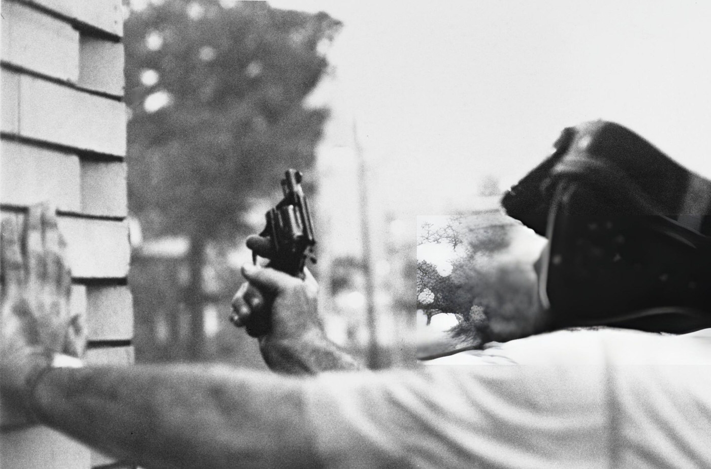 #39 A Newark police officer shelters from a sniper