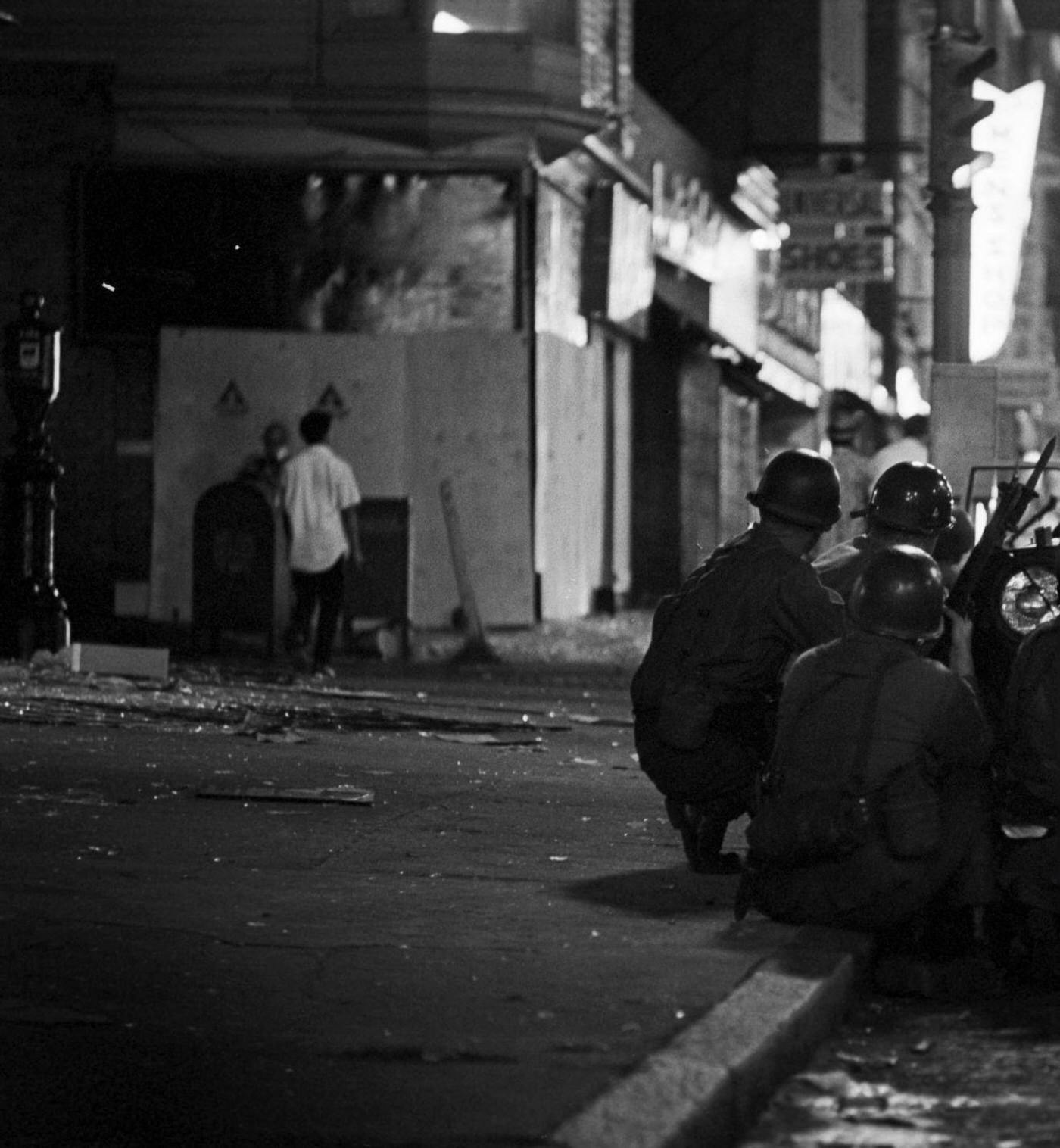 #56 National Guard soldiers take cover behind a jeep armed with a light machine gun