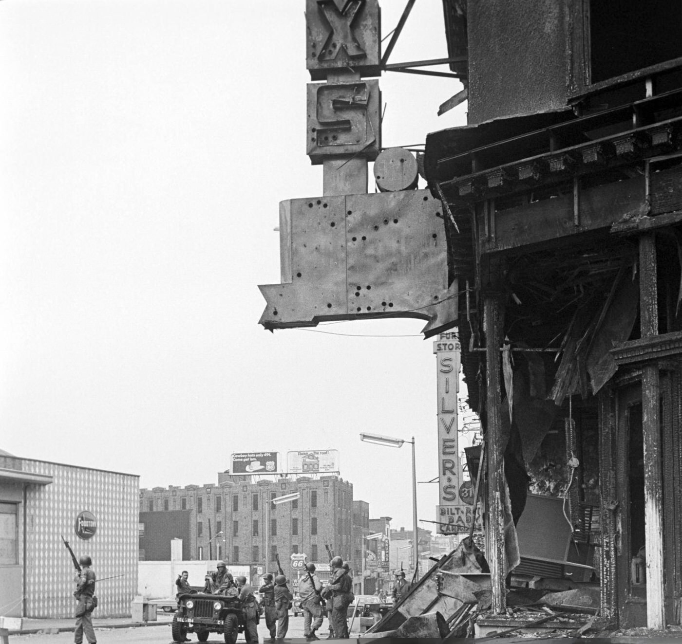 #63 A troop of armed National Guard soldiers patrol near a jeep armed with a light machine gun