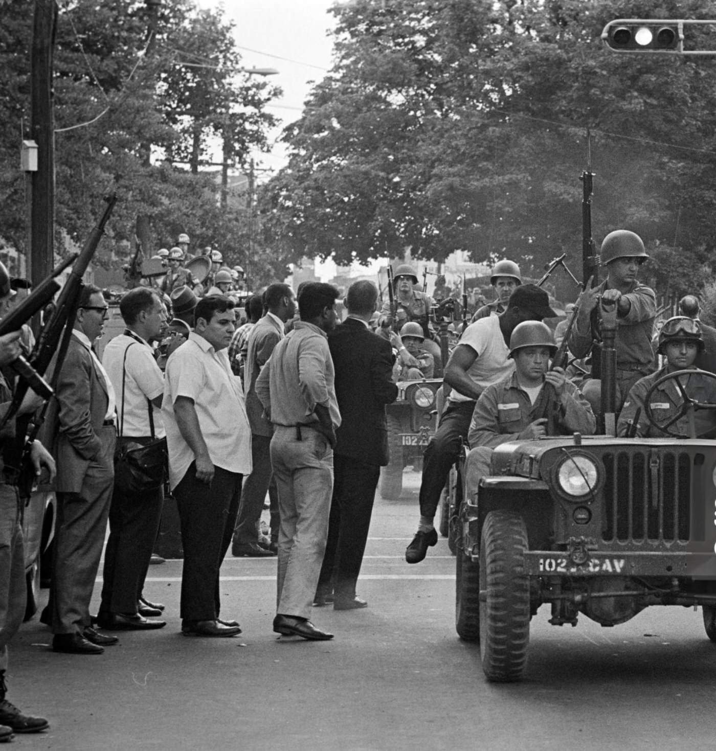 #78 A regiment of the federal guard and state police driving jeeps in single file on an avenue