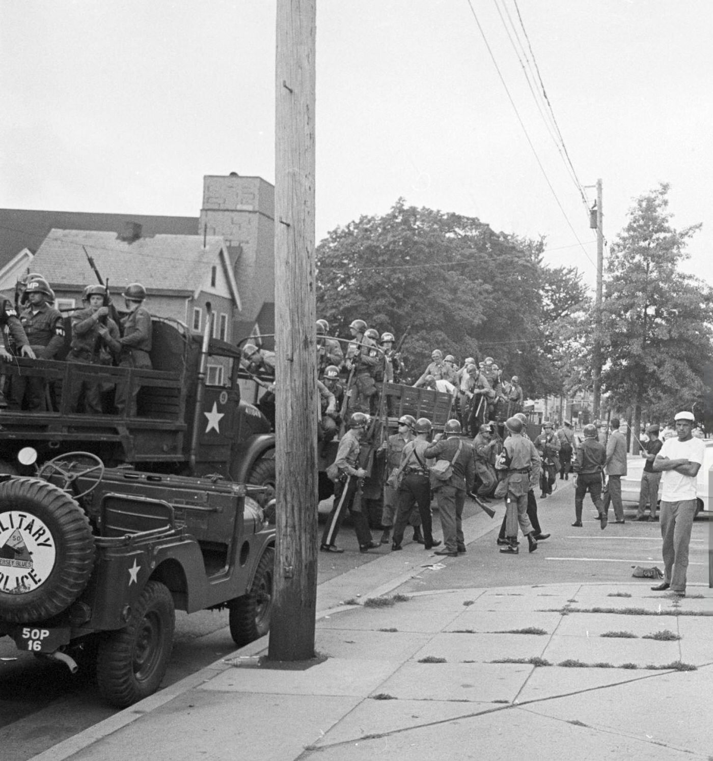 #79 Military jeeps and trucks occupied by soldiers of the federal guard on an avenue