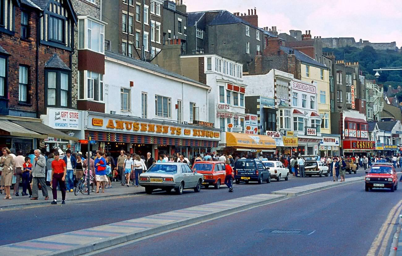 #4 Scarbrough sea front with amusement places and tourists on a summer day in the 1980’s