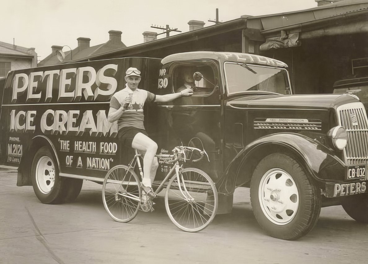 Hubert Opperman eating an ice cream next to a Peter’s Ice Cream Reo truck, 1936.