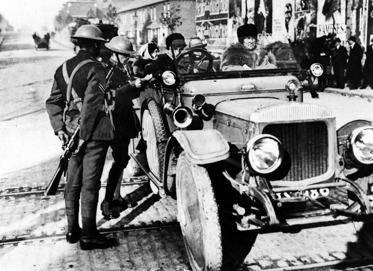 #40 Officers examining the licence of a lady motorist in Dublin, 1920.