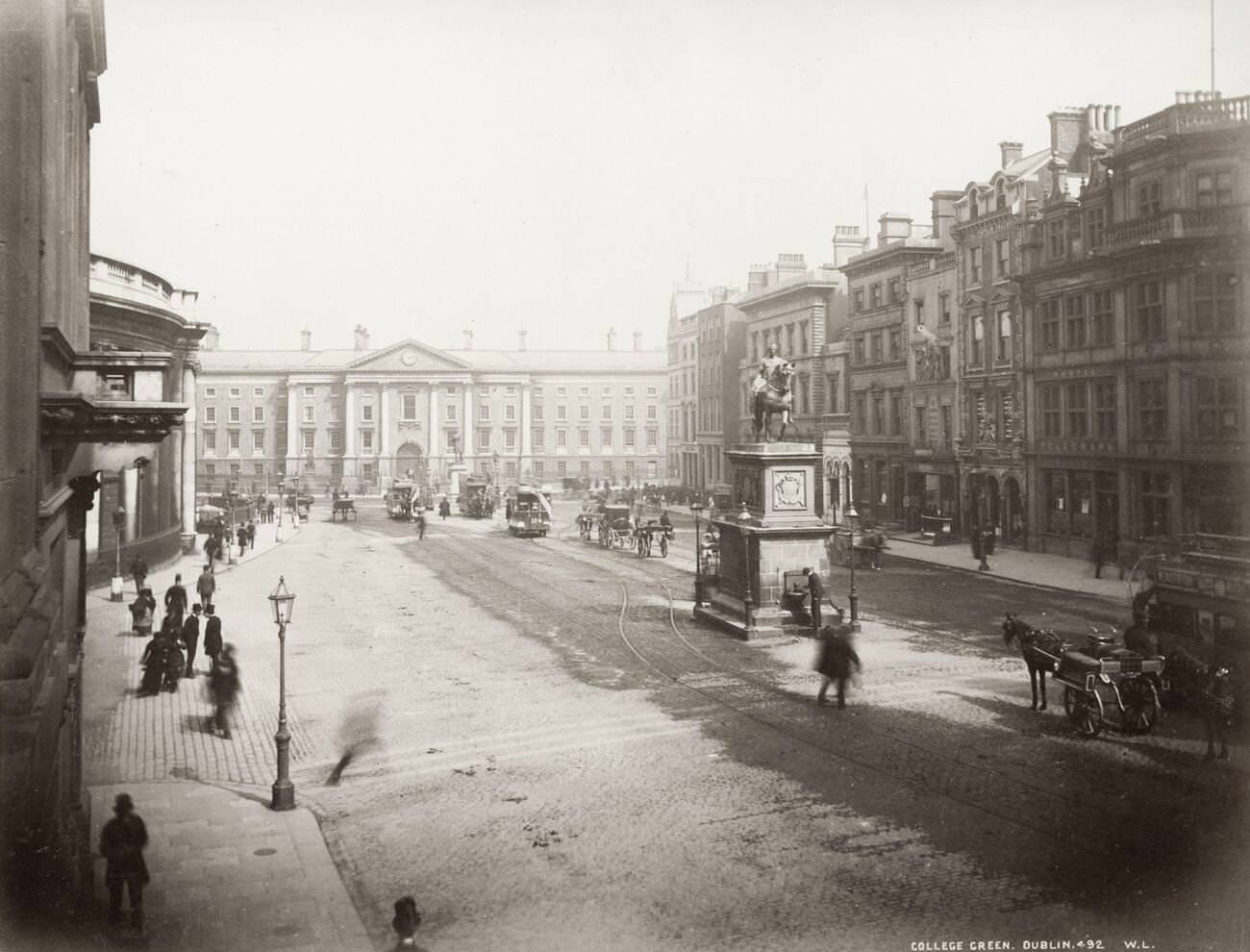 #12 College Green Dublin, with Trinity College in the background, horses and trams, 1890s