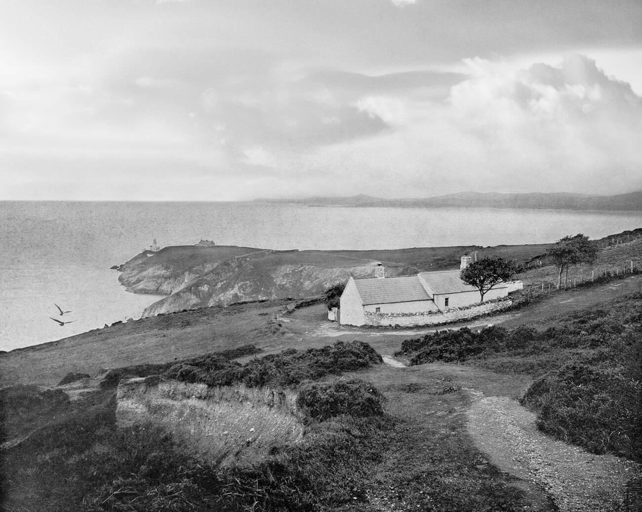 #53 Dublin Bay from Howth Head with cottages and a distant Baily Lighthouse A new tower, 41 metres (134 ft) above the sea, designed by George Halpin Senior, the corporation’s Inspector of Works, was completed on 17 March 1814.